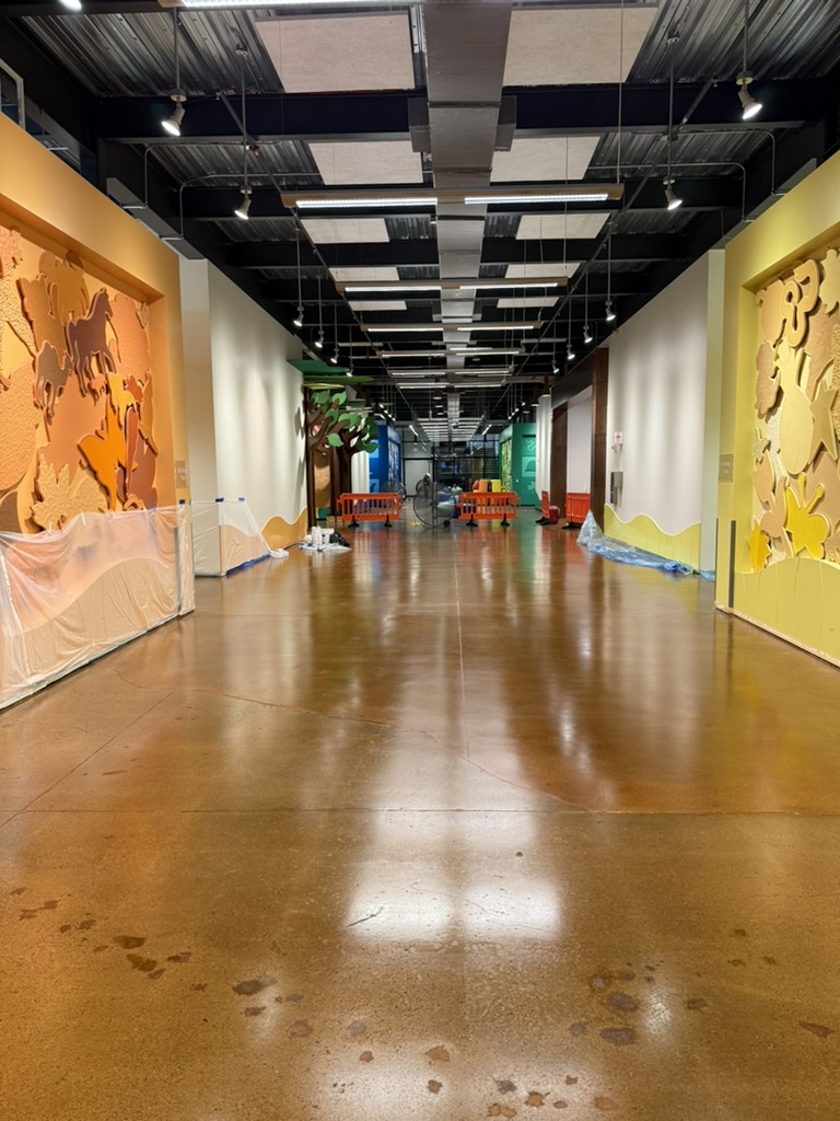 Glossy floor finished while barricades keep the corridor protected