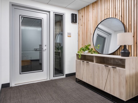 Entry with wood slat wall and mirror